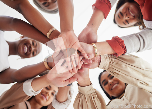 Image of Team, business people and hands together, solidarity and support, low angle and collaboration in meeting. Teamwork, trust and community with diversity, female group and happy women with hand stack