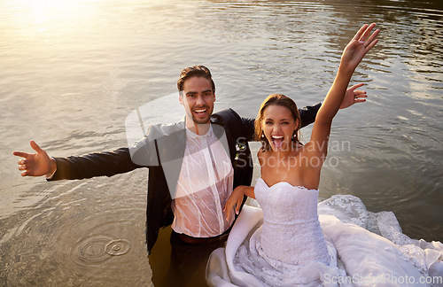 Image of Lake, portrait of wet bride and groom standing in water together with excited smile and playful romance. Love, marriage and happy couple celebrate romantic, loving relationship and wedding in nature.