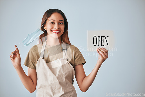 Image of Coffee shop, covid and a woman holding an open sign in studio on a gray background after lockdown. Portrait, small business startup and cafe with a female entrepreneur indoor to display advertising