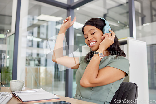 Image of Black woman, music and headphones in office with happy energy, relax and dancing for mental health and working. Professional worker or business person listening to audio tech for workplace wellness