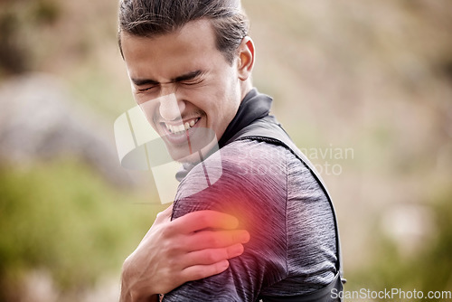 Image of Sports, injury and man with pain in shoulder outdoors after exercise, training and workout in nature. Fitness, medical emergency and male athlete with joint inflammation, muscle ache and tendinitis