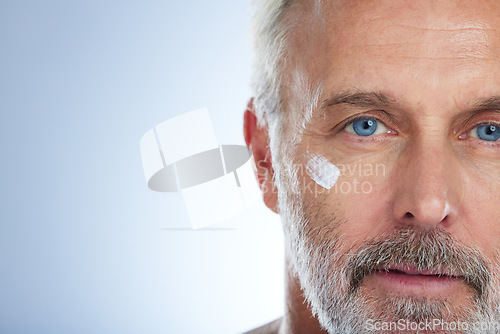 Image of Senior man, cream and portrait, face with skincare and beauty, hygiene and grooming on studio background. Lotion, moisturizer and dermatology mockup, anti aging cosmetic care and serious male closeup