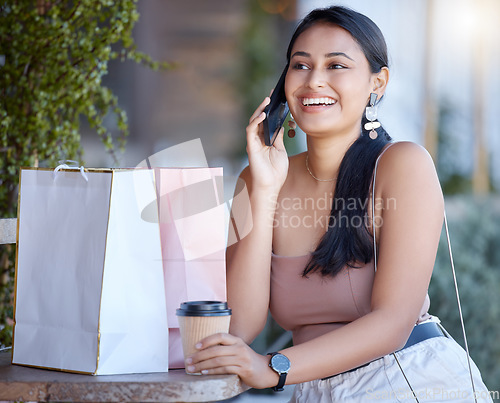 Image of Woman with shopping bag, phone call and relax at coffee shop after retail therapy, fashion and rest. Female outdoor, latte drink and communication with chat, smile and happy with discount and sale