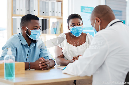 Image of Covid, medicine and doctor consulting a black couple in a hospital for wellness, insurance or treatment. Medical, health or trust with a healthcare professional talking to a man and woman in a clinic