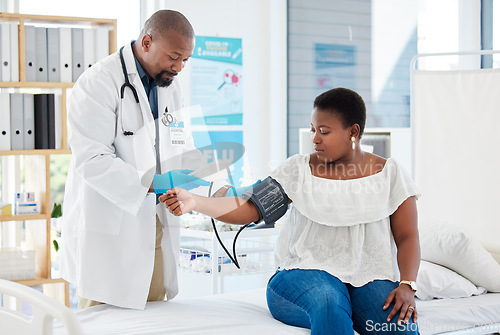 Image of Checkup, healthcare and a doctor with a black woman for hypertension, health check and service. Help, medical and a gp consulting with a patient for blood pressure exam, cardiology or monitor