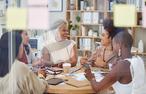 Image of Collaboration, meeting and management with business women in an office, talking strategy as a team. Teamwork, planning or partnership with a colleague group in discussion at work through glass