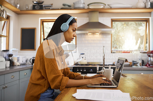 Image of Laptop, remote work and a woman with focus music, typing email and working on a proposal. Serious, headphones and a freelance worker with a computer for home business, budget and finances online