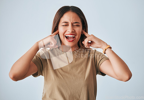 Image of Woman, frustrated and fingers in ears, studio background and shouting with anger, annoyed and problem. Student girl, anxiety and model for mental health, angry face and depression by grey backdrop