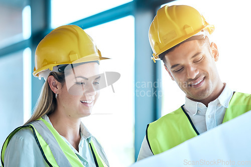 Image of Architect, team and planning with blueprint for construction or architecture with smile for on site project. Man and woman contractors in building floor plan or teamwork strategy with safety helmets