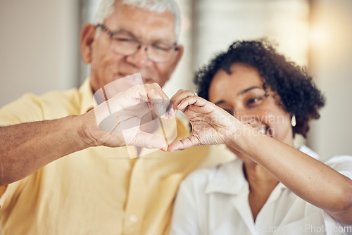 Image of Heart, hands and senior couple in a living room with emoji for hope, love and trust in their home. Hand, shape and support symbol by old people happy with retirement, lifestyle and marriage together