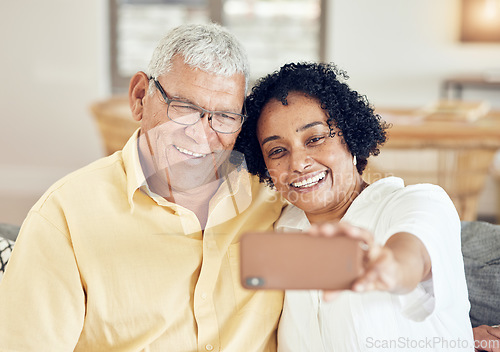 Image of Senior couple, smile and selfie in home with love, bonding and hug for support, relax and peace on blog app. Elderly man, old woman and social media for profile picture with tech in living room