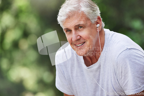 Image of Senior man, exercise and outdoor with music earphones for run, workout and training for fitness. Elderly male happy on break, rest and tired thinking of cardio audio for health and wellness in nature