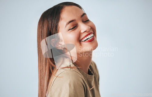 Image of Woman, laughing and happiness of a gen z female in a studio with gray background. Isolated, happy and smile from a young person feeling carefree, youth and confidence with laughter from funny joke