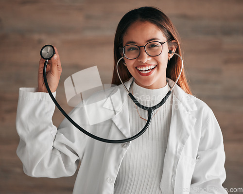 Image of Healthcare, happy and portrait of a doctor with a stethoscope isolated on a clinic wall. Smile, consulting and a woman in medicine for a consultation, cardiology and medical analysis at a hospital