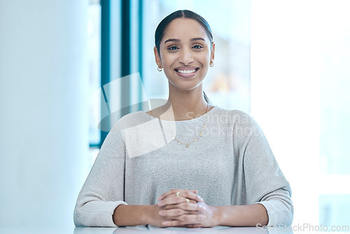 Image of Happy, corporate and portrait of a woman at a table for a meeting, interview or management. Smile, executive and an employee sitting at a desk for administration, secretary work and human resources