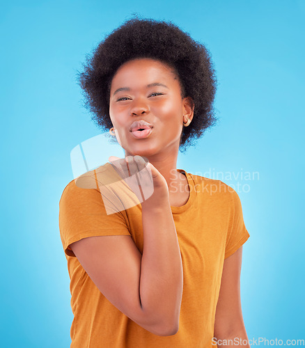 Image of Portrait, black woman and blowing kiss on blue background of love, care and flirting in studio, color backdrop and face. Happy female model, hand kisses and emotion of happiness, fun or kissing emoji