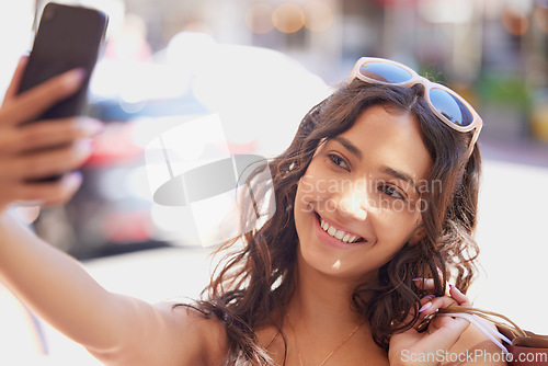 Image of Woman, street and selfie with shopping, bag and smile for fashion, discount and social network app in summer. Gen z influencer girl, smartphone photography and profile picture for internet in city