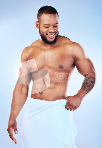 Image of Towel, shower and fitness body of a black man with happiness from bodybuilder muscle. Cleaning, skincare and wellness after sport workout and exercise with isolated, studio and blue background