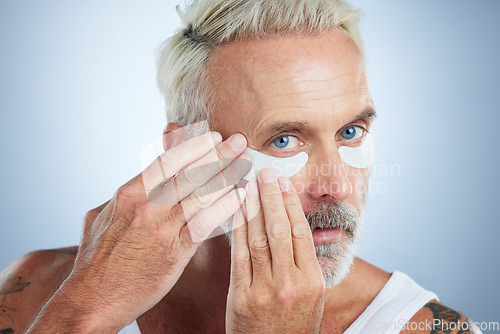 Image of Beauty, eye mask and portrait of senior man in studio for wellness, facial treatment and anti aging cosmetics. Skincare, dermatology and face of male model with patches for detox, wrinkles and eyes