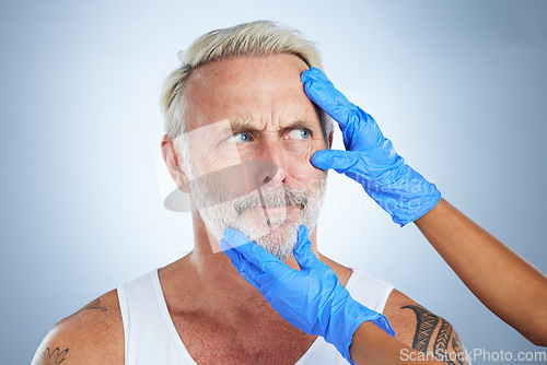 Image of Needle, confused face and senior man in a studio doing plastic surgery and cosmetic skincare. Dermatology gloves, wrinkles and anti aging treatment of a mature model prepare for medical procedure