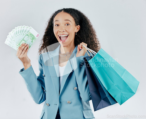 Image of Happy woman, portrait and shopping bags with money winning sale or discount against white studio background. Excited and surprised female shopper smiling with cash, gift or profit in retail happiness