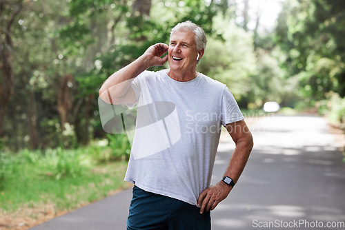 Image of Happy, talking and man on a phone call while running, speaking about fitness and exercise in nature. Thinking, smile and a senior person laughing on a mobile while in a park for cardio and workout