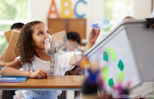 Image of Learning, recycle bin and girl in classroom throwing trash for cleaning, climate change or eco friendly in school. Recycling plastic, smile and education with happy student or kid in kindergarten.
