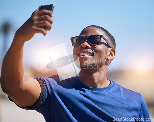 Image of Fitness, selfie and black man runner with phone outdoor for training, running or exercise on blurred background. Happy, guy and social media health influencer smile for photo, profile picture or blog