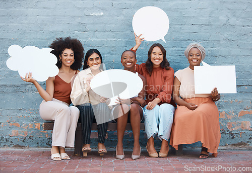 Image of Portrait, speech bubble and diversity with business women outdoor, holding blank space for text. Collaboration, social media and communication with a happy female employee team sitting on a bench