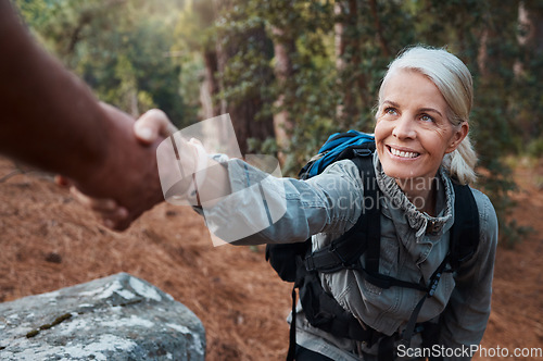 Image of Hiking, helping hand and people in nature for climbing adventure, senior wellness and support for health. Happy woman or couple of friends hands reaching for teamwork on mountains or forest trekking