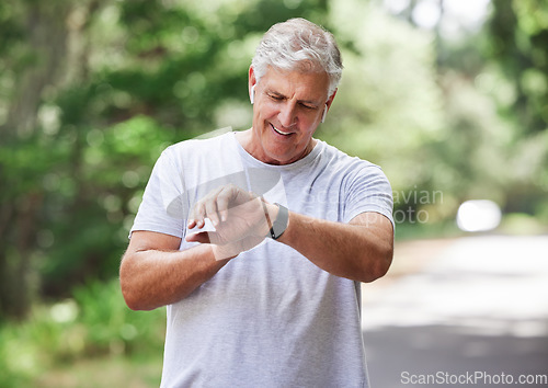 Image of Senior man, watch and outdoor for exercise time to run, workout and training on road for fitness. Elderly male person happy about cardio progress for health and wellness while running in summer