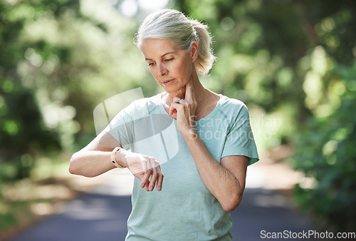 Image of Senior woman, watch and pulse outdoor for exercise on run, workout and training on road for fitness. Elderly female person check cardio progress time for health and wellness while running in nature