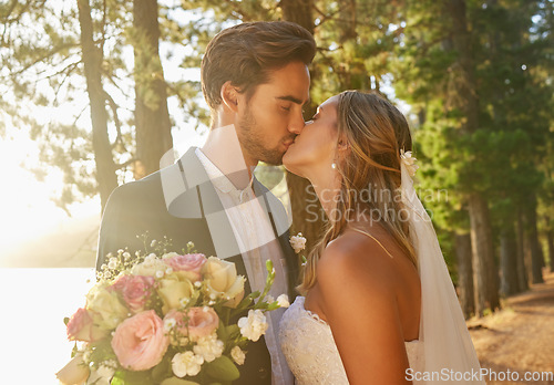 Image of Wedding, married and couple kiss in park, forest and nature for celebration of love, care and marriage commitment. Bride, groom and kissing in garden for romance, bridal event and celebrate ceremony