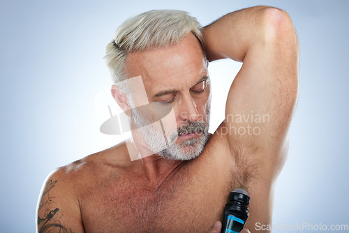 Image of Skincare, deodorant and senior man for wellness, body hygiene and cleaning products on blue background. Beauty, grooming mockup and elderly male with antiperspirant, fragrance and underarm in studio