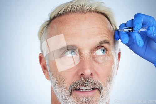 Image of Botox, face closeup and senior man in a studio looking at plastic surgery doctor doing cosmetic skincare. Dermatology, wrinkles and anti aging treatment of a model with silicone filler injection