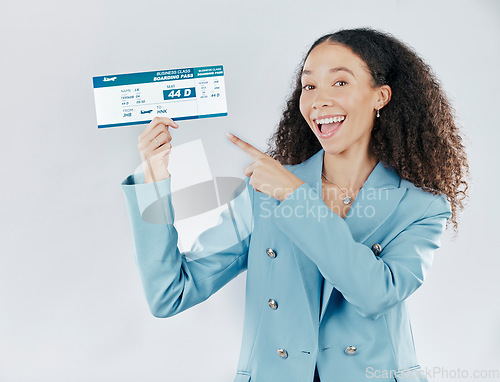 Image of Business woman, plane ticket and portrait pointing for international travel or boarding pass against white studio background. Happy female traveler smiling for global trip, flight booking or document