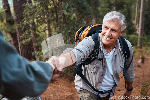 Image of Help, holding hands and couple hiking in nature, climbing support and giving a hand. Happy, together and a person helping a senior man up a hill while on a walk in the mountains for exercise