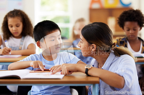 Image of Teacher, learning and helping boy in classroom for knowledge, studying or assessment. Preschool, development and Asian kid or student with woman for education assistance with notebook in kindergarten