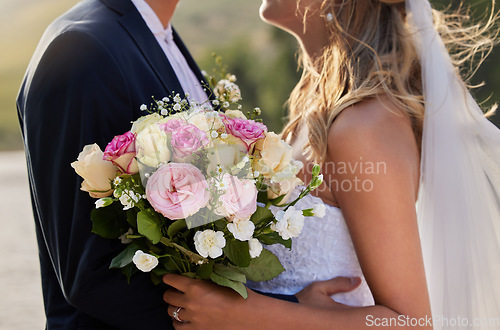 Image of Flower bouquet, marriage hug and wedding ceremony couple for unity commitment, romantic trust or union event. Bridal flowers, love and body embrace of groom, bride or fiance in solidarity and support