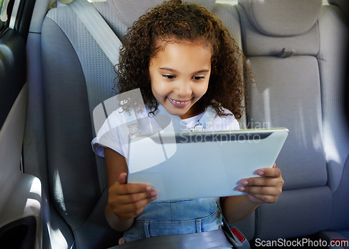 Image of Happy, car and girl with tablet, safety and streaming cartoons with happiness, relax and apps. Young person, female child and kid with device, vehicle and travelling with smile, connection and calm