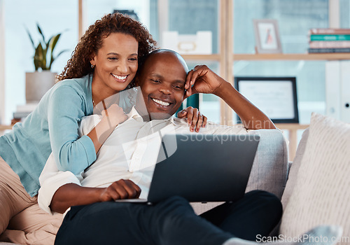 Image of Laptop, relax and a couple watching a movie on a sofa in the living room of their home together for entertainment. Computer, video or streaming with a man and woman enjoying a series while bonding