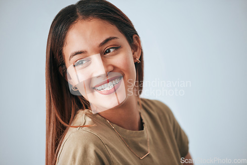 Image of Woman, smile and happiness of a gen z female in a studio with gray background. Isolated, happy and beauty from a young person feeling carefree, relax youth and confidence with female empowerment