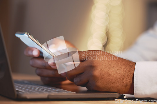 Image of Business man, hands and phone by a laptop typing a message for work networking. Hand closeup, bokeh and online management of a employee working and planning a job schedule with technology and email