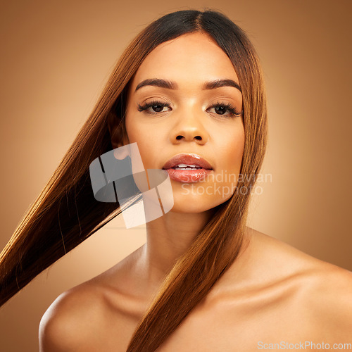 Image of Haircare, beauty and serious portrait of woman in studio with straight hair, texture and salon shine. Latino model, healthy brunette hairstyle and natural keratin product on brown background space.