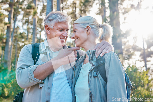 Image of Love, nature and senior couple on a hike together in a forest while on outdoor weekend trip. Happy, intimate moment and elderly man and woman in retirement trekking in woods to explore and adventure.