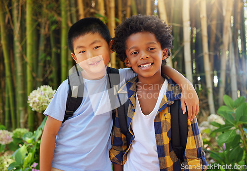 Image of Friends, children and portrait outdoor in nature for field trip in summer with diversity and happiness. Asian and black boy kids together in a forest for adventure and summer trip with a backpack