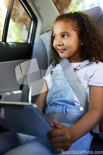 Image of Child in car, smile and tablet on road trip with seatbelt for safety and device to watch educational video or online game. Technology, internet and travel, happy girl on backseat for drive or carpool