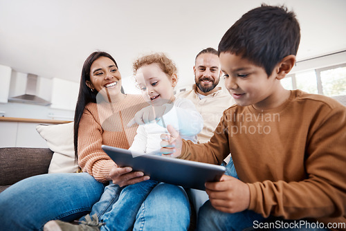 Image of Happy, tablet and bonding with family on sofa for search, streaming and fun games. Technology, internet and connection with parents and children browsing online at home on social media app or website