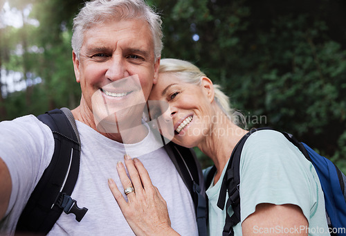 Image of Selfie portrait, hiking and mature couple hug in forest, fitness love and outdoor health with happy blog update. Nature, travel and trekking face of mature people in woods with profile picture post