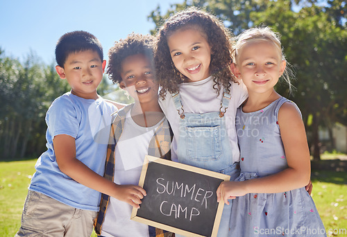 Image of Summer camp, portrait or kids hugging in park together for fun, bonding or playing in outdoors. Boys, girls or happy young best friends smiling or embracing on school holidays outside with board sign